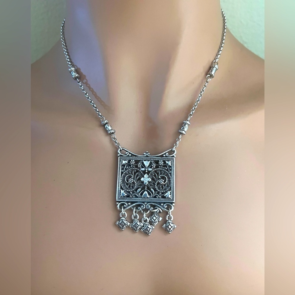 Brighton pendant necklace.
Square pendant with loose charms. 10" long clasped.